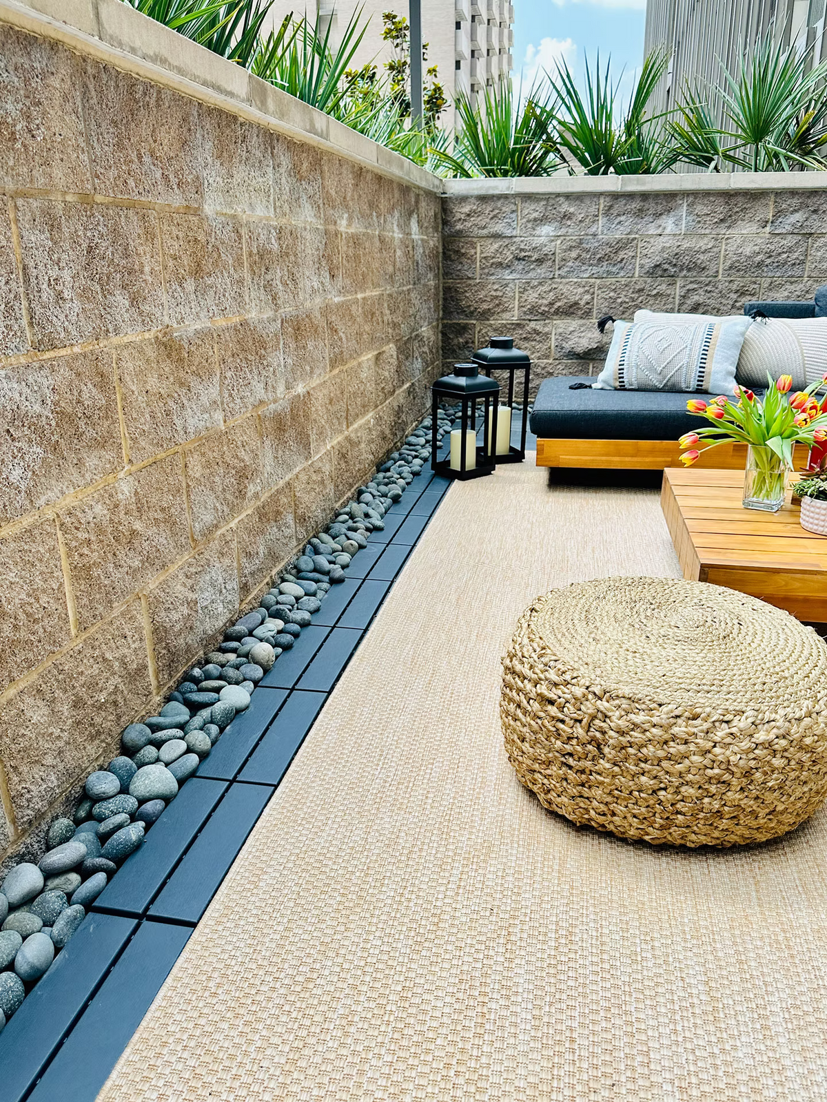The fastest way to glam up that cold concrete balcony floor?  Add a pebble border.